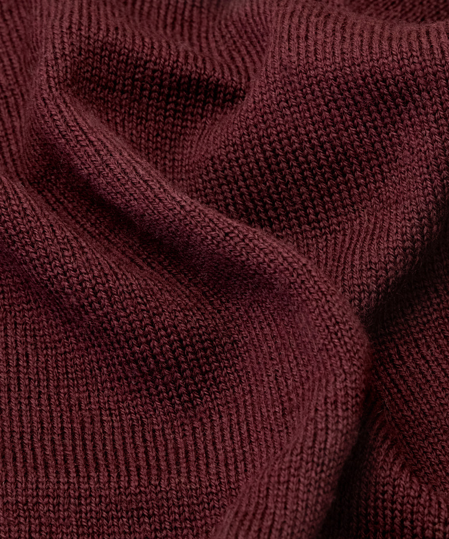 Atmungsaktiv & wärmend*Merinofasern sind aufgrund ihrer natürlichen Eigenschaften atmungsaktiv und helfen so, die Körpertemperatur zu regulieren.|Nahaufnahme gestrickter Schlauchschal in Bordeaux.