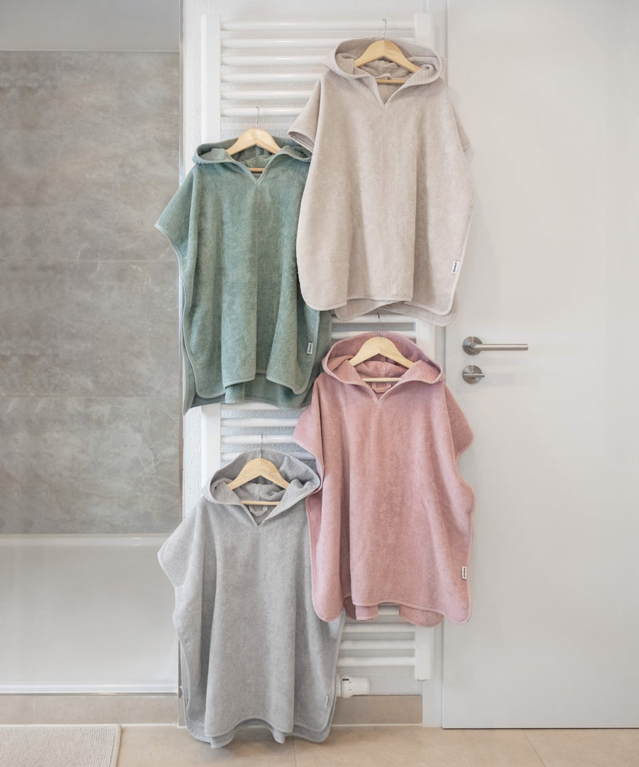 Tolle Farben*Für jeden Geschmack etwas dabei: Unser Badeponcho ist in fünf frischen Farben erhältlich.| Badeponchos sind an der Heizung aufgehangen.
